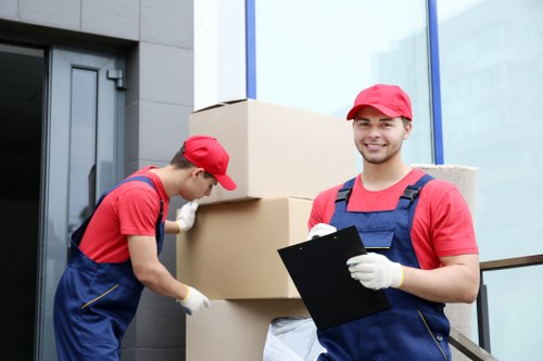 Team preparing boxes and office equipment for a commercial move in London