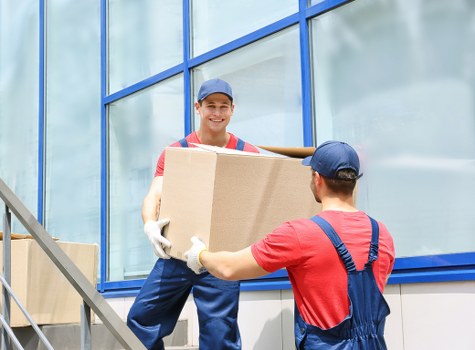 Moving staff using proper lifting techniques for heavy items