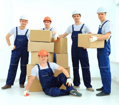 Packers organizing fragile household items during a London move