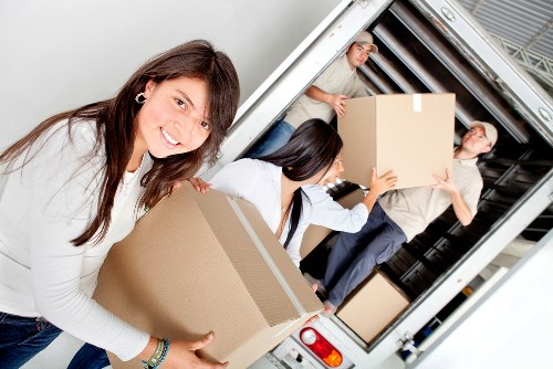Professional movers loading a London removal van