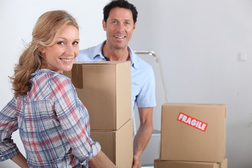 Team planning furniture removals in London with measuring tools and protective wrap